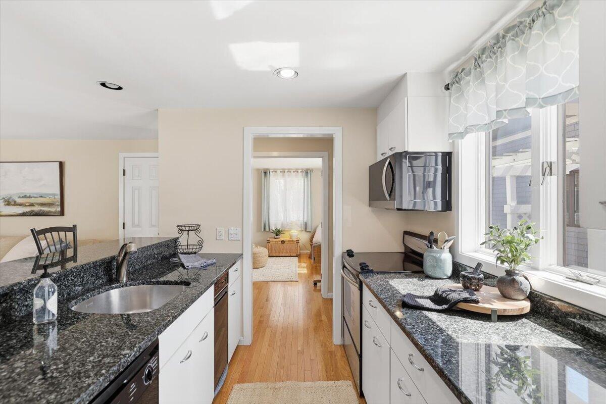 100 Mid-Iron Way, Unit 7027 Mashpee, MA 02649 - Photo 4 of 38 a kitchen with granite countertop a sink and a counter top space