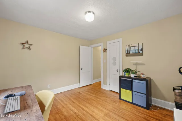 a bedroom with a bed and a desk