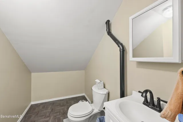 a white toilet sitting next to a bathroom sink