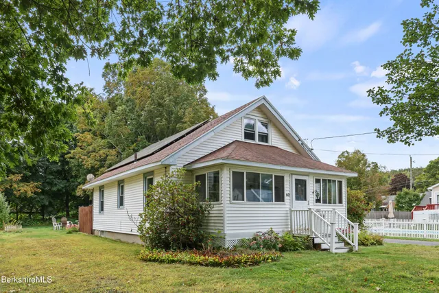 a front view of house with yard and green space