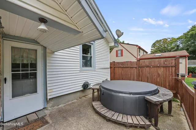a view of a house with a yard and potted plants