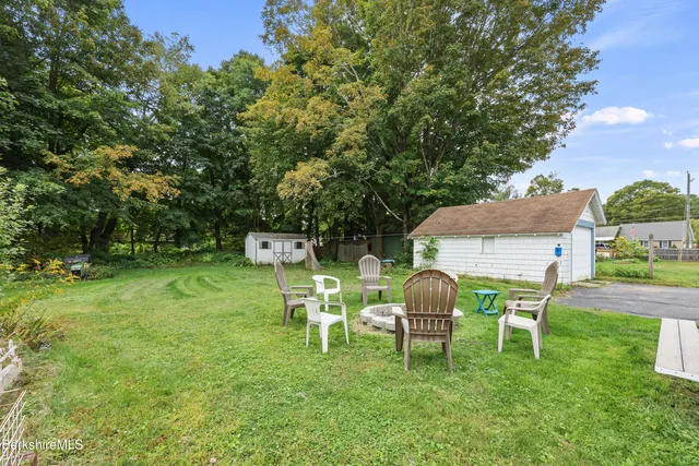 a view of a chair and table in the garden