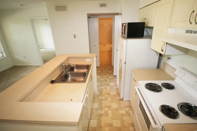 a kitchen with a stove and a refrigerator