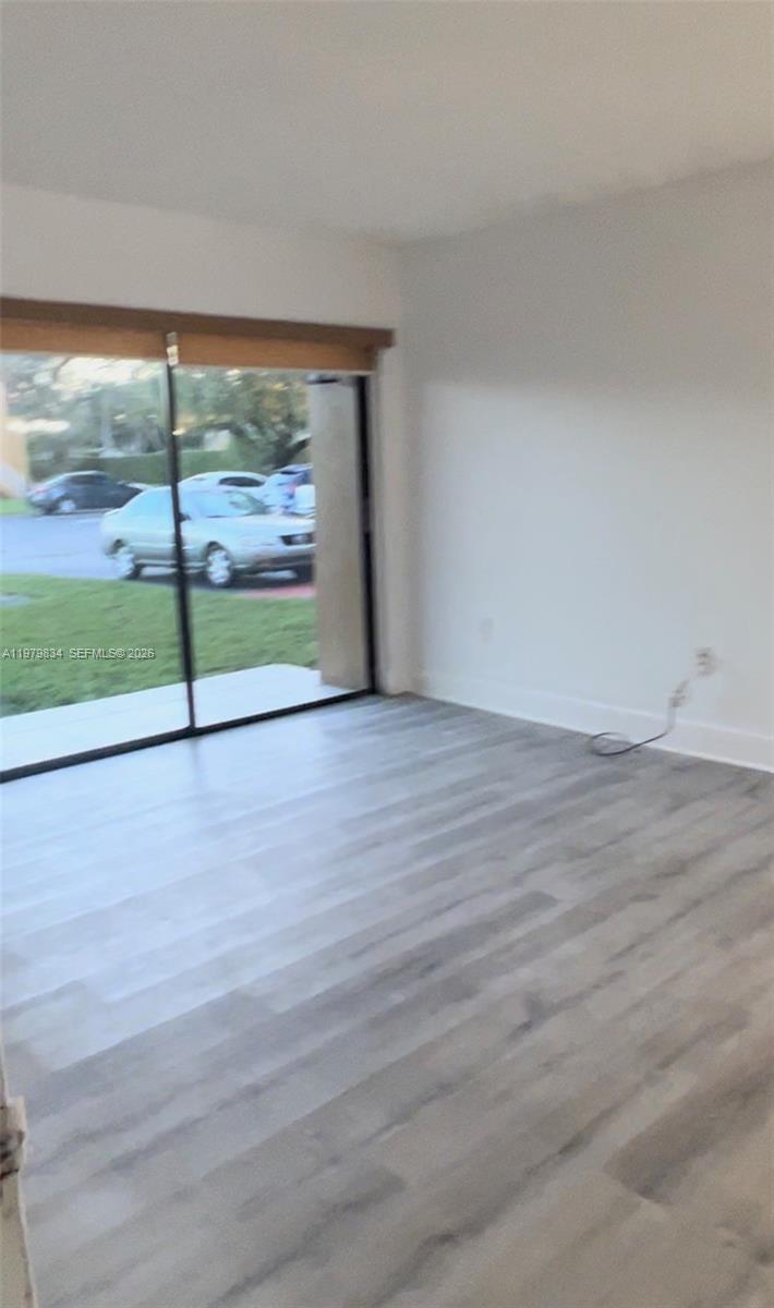 15640 Southwest 80th Street, Unit G103 Miami, FL 33193 - Photo 2 of 11 a view of a room with wooden floor and windows