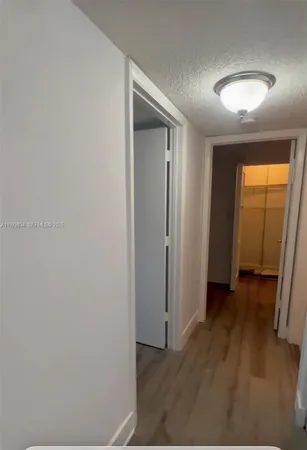 an empty room with wooden floor and closet