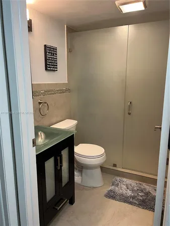 a bathroom with a toilet a sink and a shower