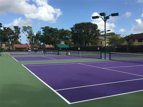 a view of a patio with table and chairs under an umbrella