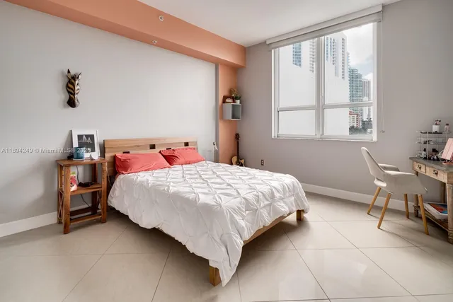 a bedroom with a bed and window