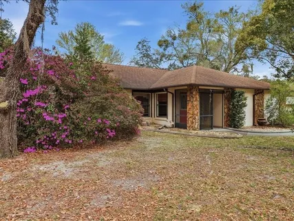 a view of a house with a garden and pathway