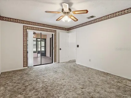 a view of a livingroom with a ceiling fan and window