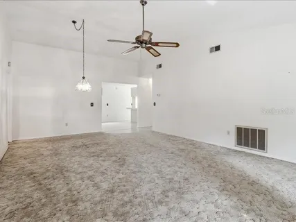 a view of a room with a ceiling fan and a wooden floor