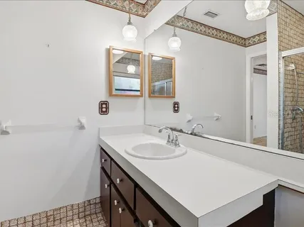 a bathroom with a sink a vanity and a mirror