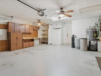 a view of a kitchen with refrigerator and cabinets
