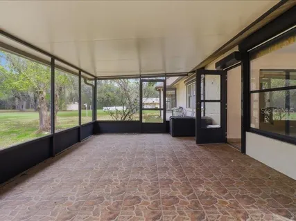 wooden floor in an empty room with a floor to ceiling window