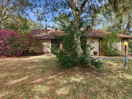 a view of a house with a tree