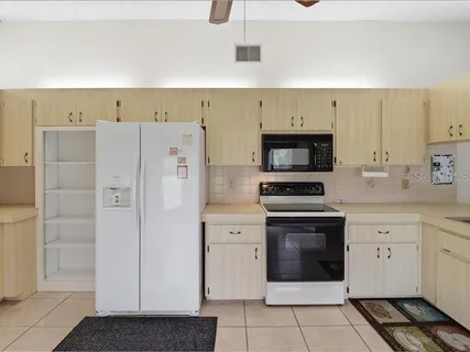 a kitchen with cabinets and steel stainless steel appliances