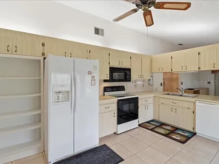 a kitchen with cabinets stainless steel appliances and a counter space