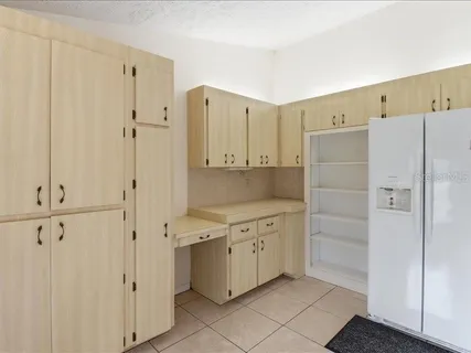 a kitchen with cabinets and a stove top oven