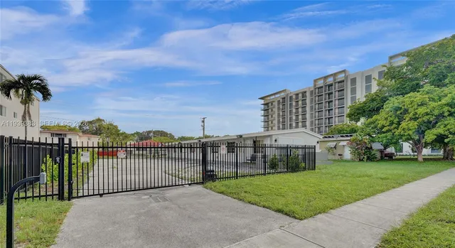 a view of a garden with a building in the background
