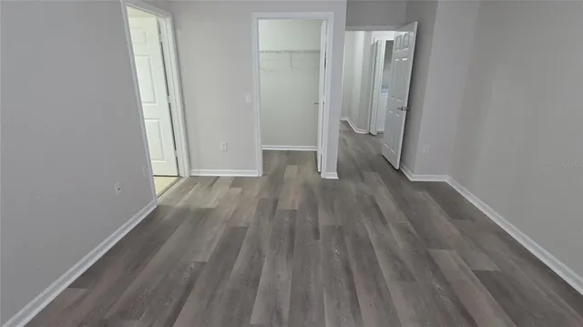 a view of a room with wooden floor and a hallway