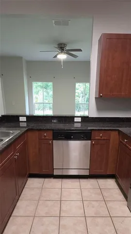 a kitchen with a sink and a stove top oven