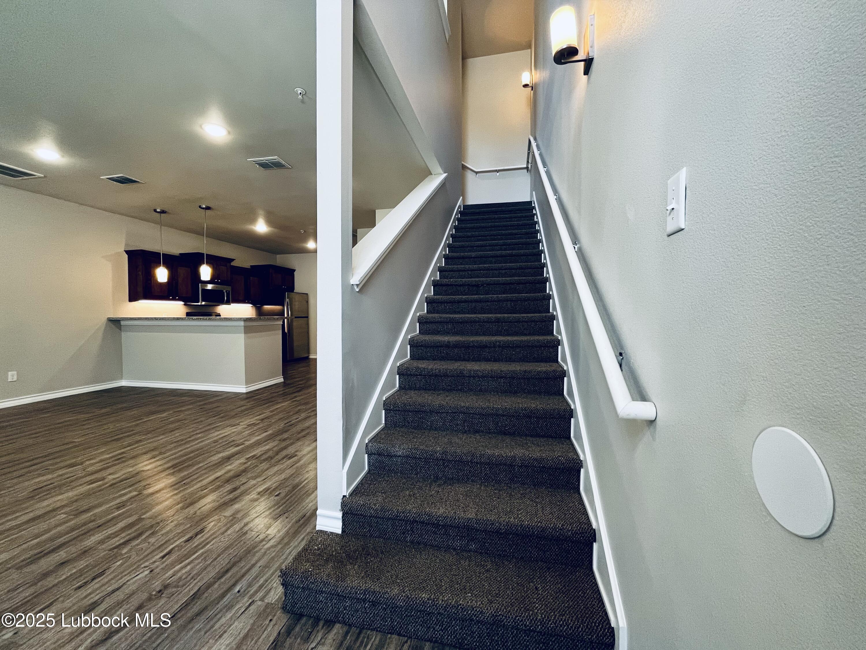 3404 25th Street, Unit 4 Lubbock, TX 79410 - Photo 11 of 15 a view of entryway and kitchen with wooden floor