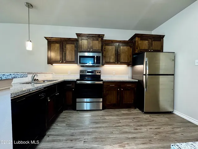 a kitchen with a refrigerator and a sink