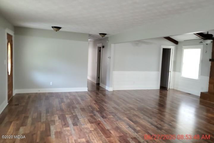 2465 Pate Road Macon, GA 31210 - Photo 6 of 28 a view of an empty room with wooden floor and a window