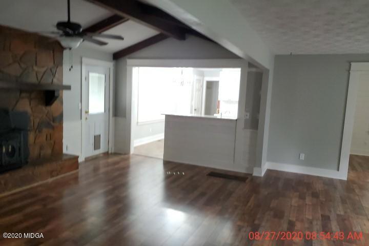 2465 Pate Road Macon, GA 31210 - Photo 7 of 28 a view of an empty room with wooden floor and a window