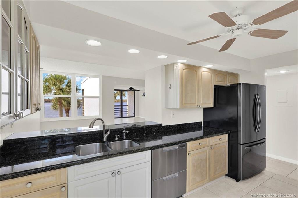 1950 Southwest Palm City Road, Unit 13301 Stuart, FL 34994 - Photo 21 of 58 a modern kitchen with stainless steel appliances granite countertop a sink a refrigerator and a counter space