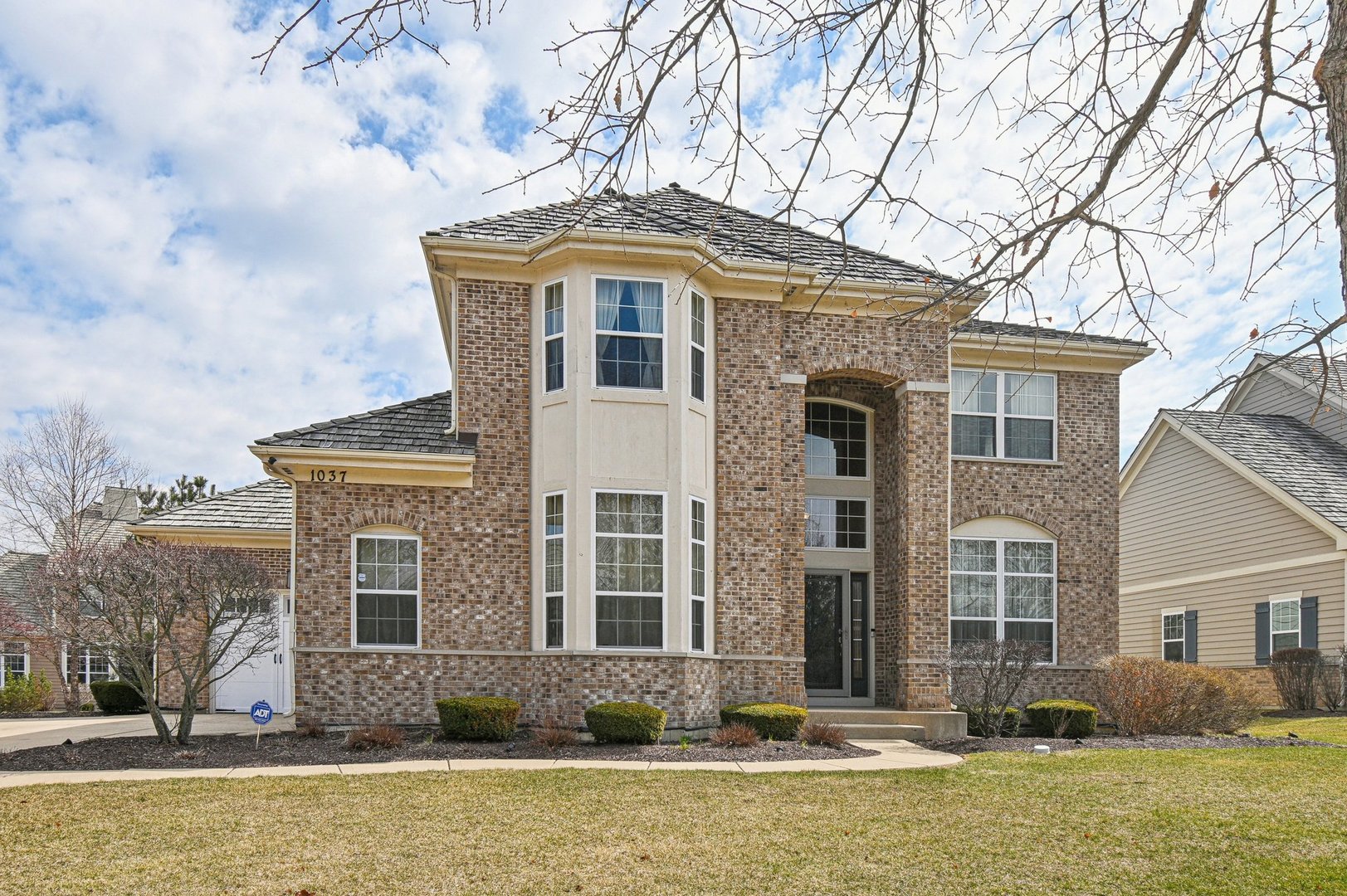a front view of a house with a yard