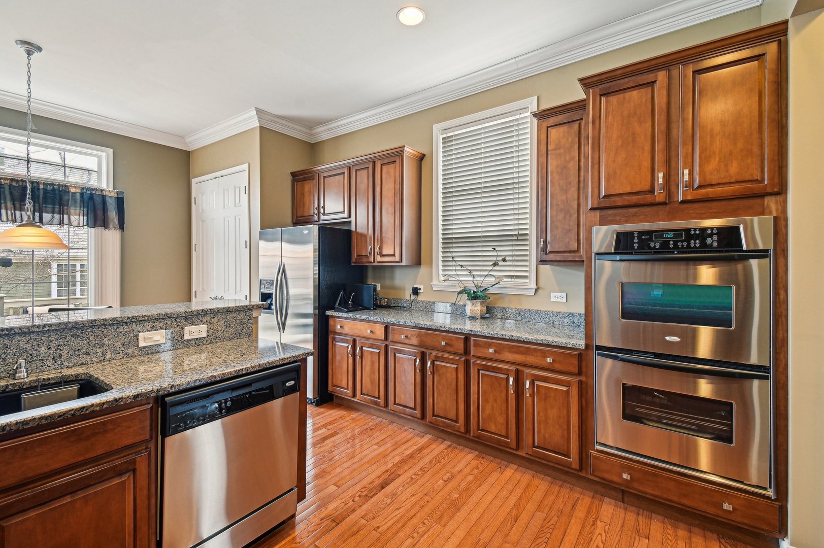1037 Moray Drive Inverness, IL 60010 - Photo 12 of 50 a kitchen with stainless steel appliances granite countertop wooden cabinets a stove a sink and dishwasher with wooden floor