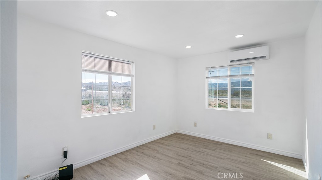 5827 Old Woman Springs Road Johnson Valley, CA 92285 - Photo 20 of 36 an empty room with wooden floor and windows