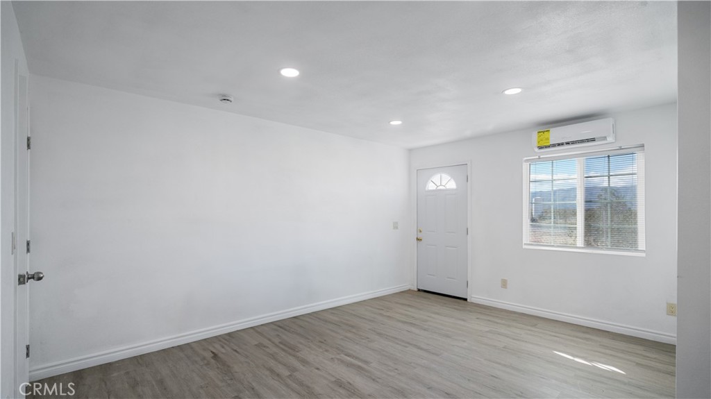 5827 Old Woman Springs Road Johnson Valley, CA 92285 - Photo 24 of 36 an empty room with wooden floor and windows