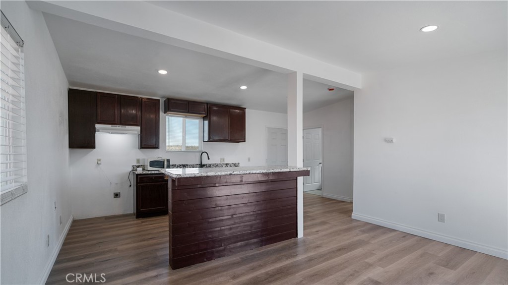 5827 Old Woman Springs Road Johnson Valley, CA 92285 - Photo 6 of 36 a kitchen with wooden floors appliances and cabinets