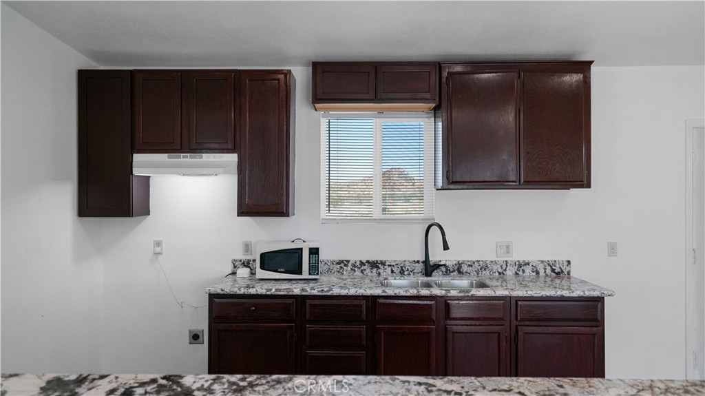 5827 Old Woman Springs Road Johnson Valley, CA 92285 - Photo 7 of 36 a kitchen with a sink and cabinets