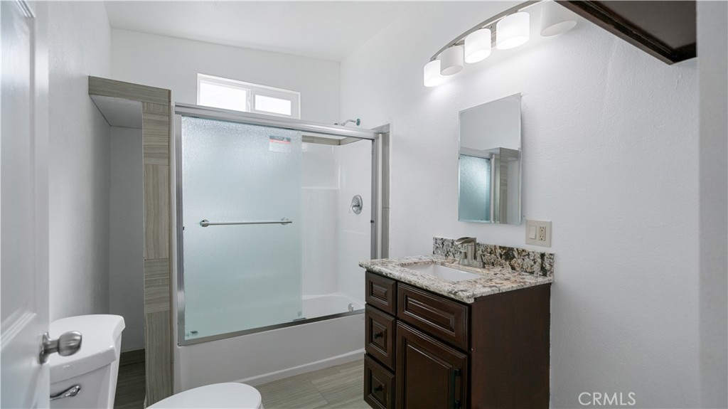 5827 Old Woman Springs Road Johnson Valley, CA 92285 - Photo 9 of 36 a bathroom with a granite countertop sink toilet and shower