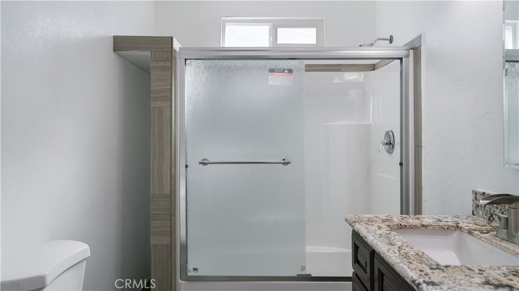 5827 Old Woman Springs Road Johnson Valley, CA 92285 - Photo 10 of 36 a bathroom with a granite countertop shower and a sink