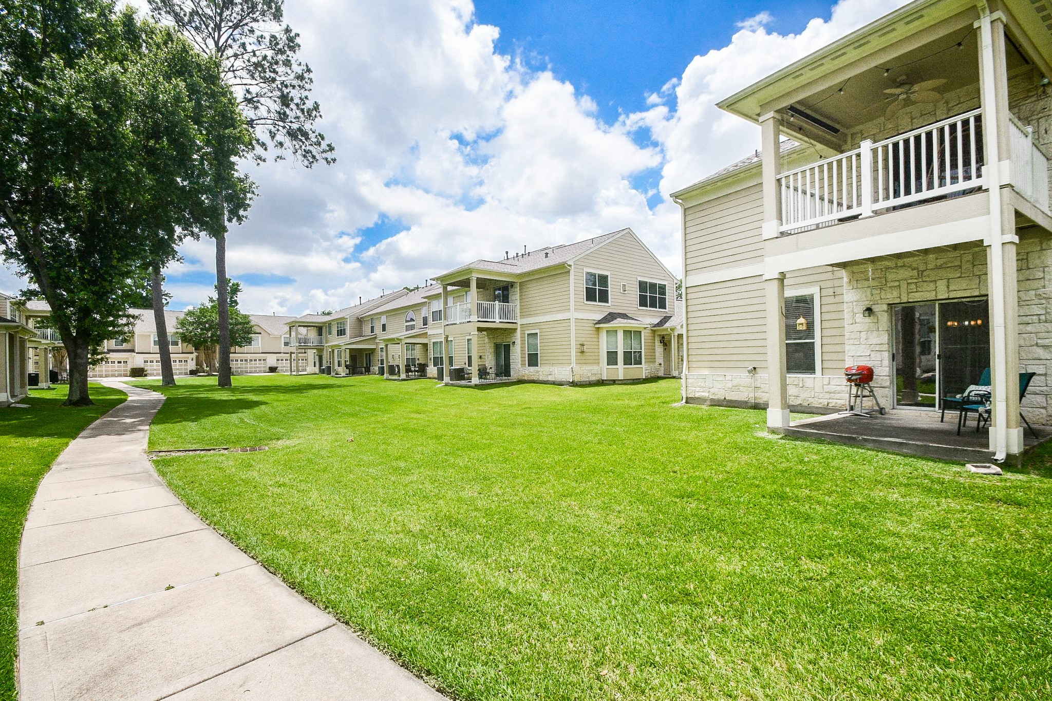 13600 Breton Ridge Street, Unit 36F Houston, TX 77070 - Photo 35 of 38 Beautifully maintained community grounds with mature landscaping.