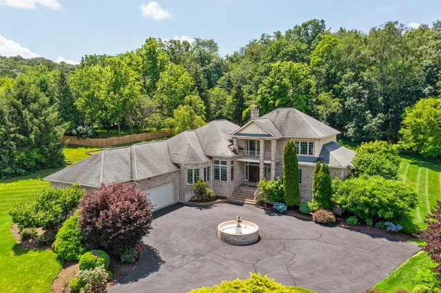 a view of a patio with furniture and a garden