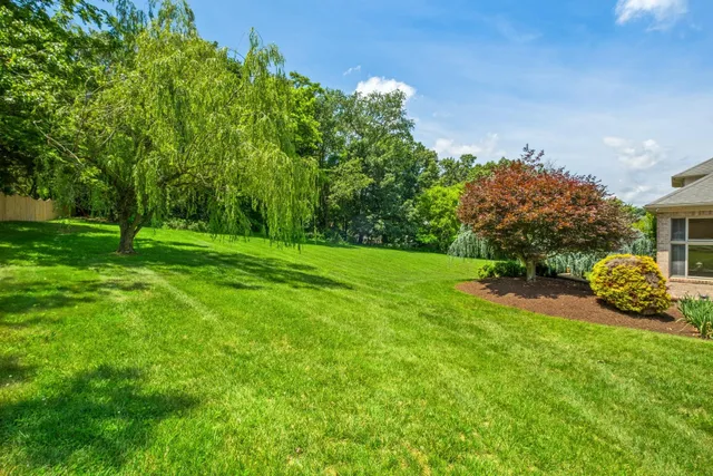 a kitchen with stainless steel appliances granite countertop a sink and a refrigerator