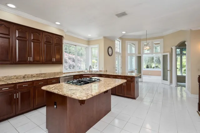 a view of an empty room with a fireplace and a window