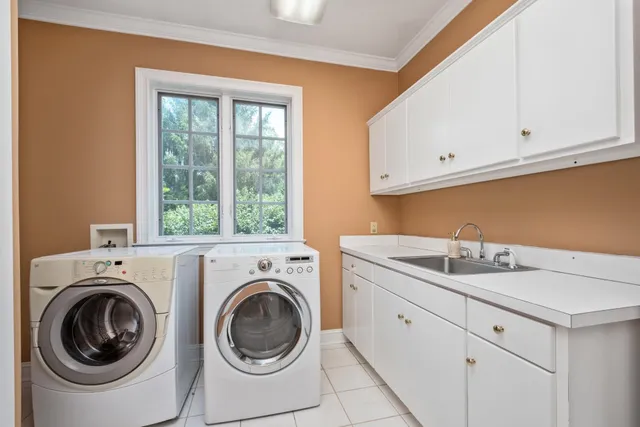 a dining room with furniture a chandelier and a rug