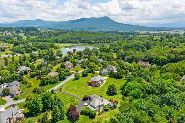 a view of green field with trees in the background