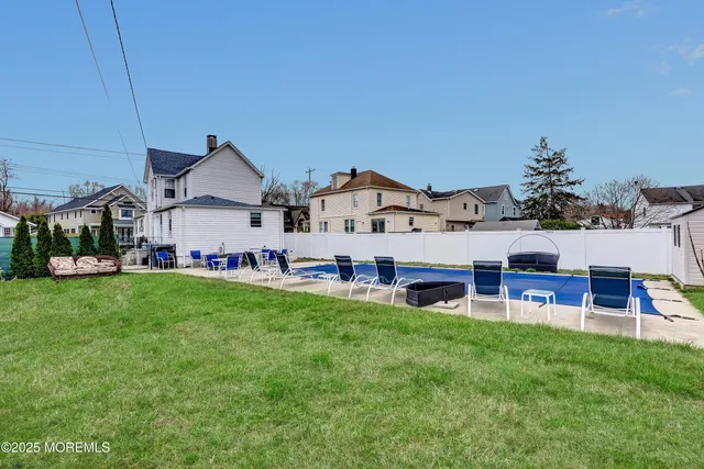 a view of a house with a yard and sitting area