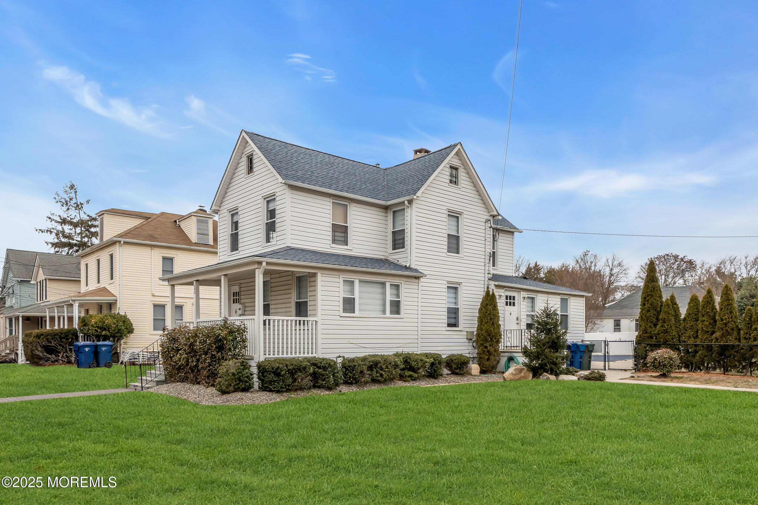 323 Roosevelt Avenue Oakhurst, NJ 07755 - Photo 2 of 19 a view of a white house with a big yard and potted plants