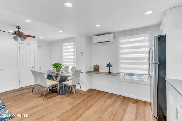 a workspace with furniture wooden floor and a window