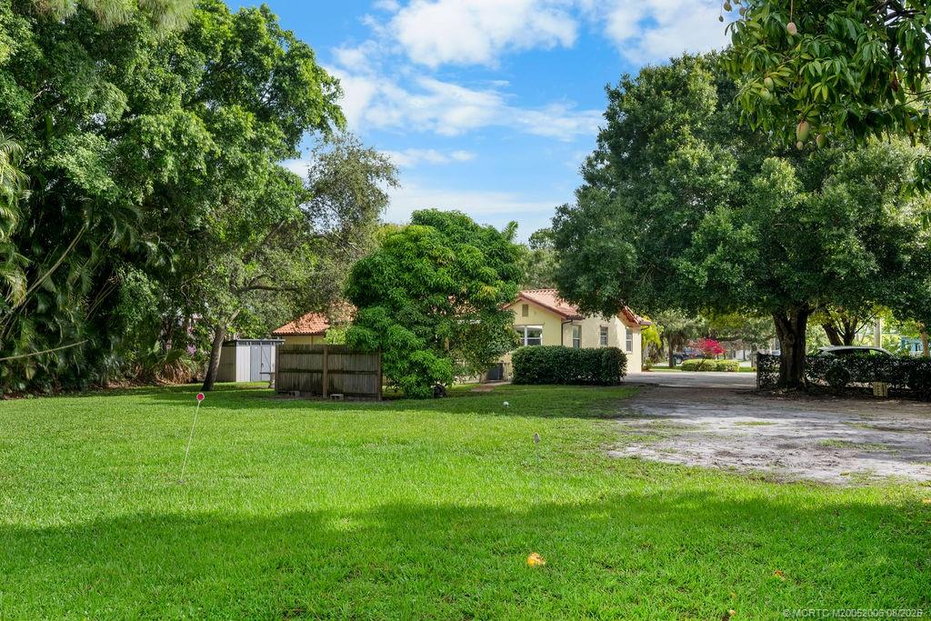 400 Southeast Flamingo Avenue Stuart, FL 34996 - Photo 21 of 33 a house view with a sitting space and garden