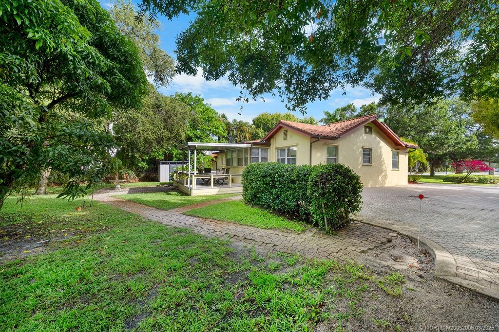 400 Southeast Flamingo Avenue Stuart, FL 34996 - Photo 26 of 33 a view of front of house with a yard