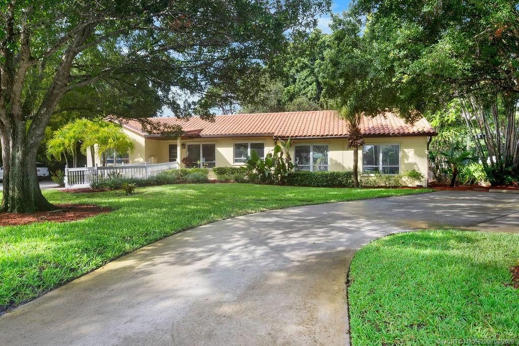 400 Southeast Flamingo Avenue Stuart, FL 34996 - Photo 3 of 33 a front view of a house with a yard